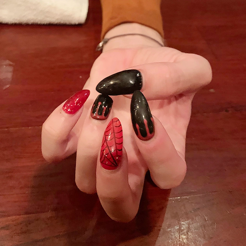 To Be Frank nail polish in red and black painted on man's hand