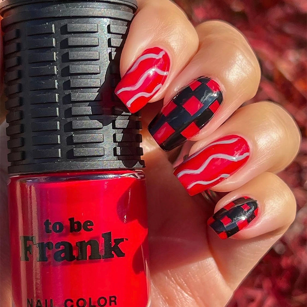 To Be Frank nail polish bottle and painted on hand in red and black