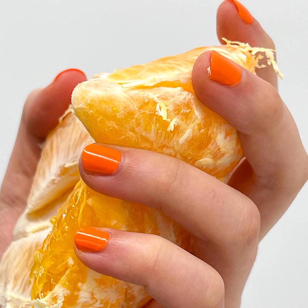To Be Frank orange nail polish named Oh, Jay holding an orange