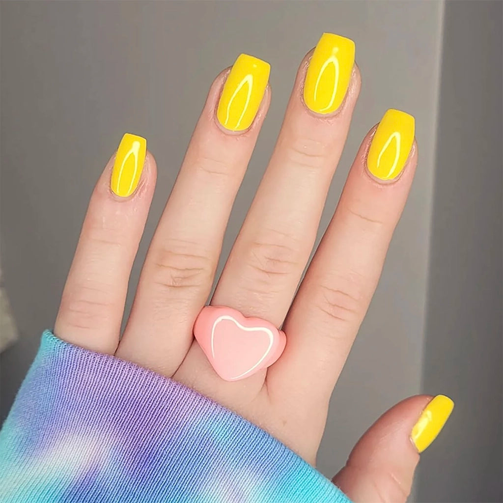 To Be Frank bright yellow nail polish named Sunny AF painted on woman's hand